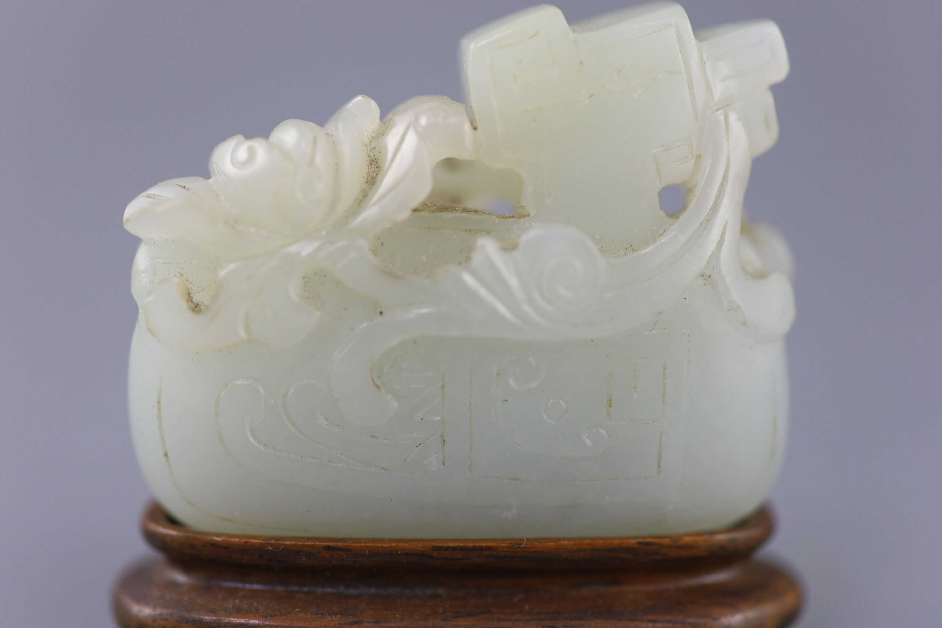 A Chinese archaistic pale celadon jade mandarin duck carving, 19th century, 5cm excluding wood stand
